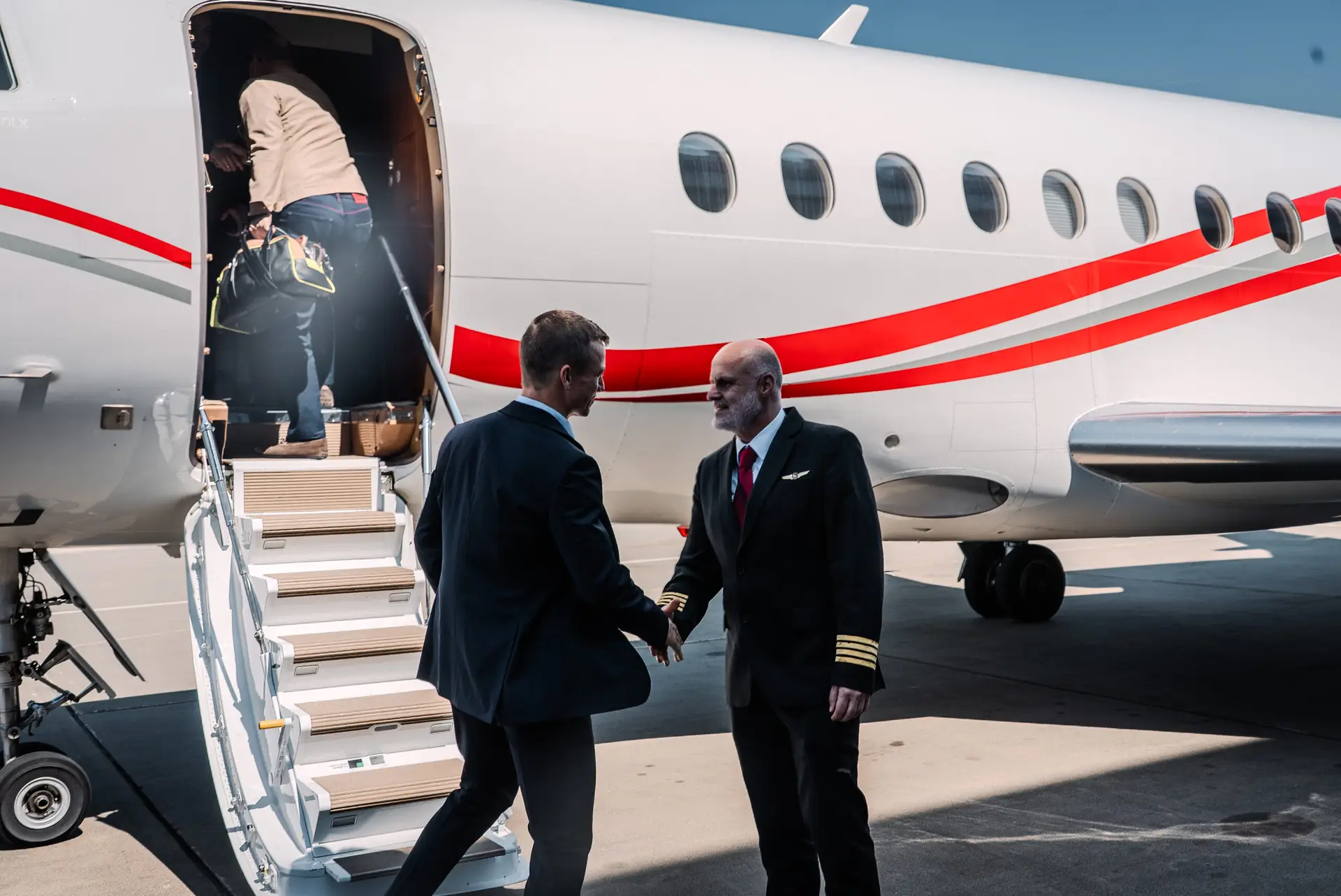 SwiftWings luxury private jet parked ready for charter the captain welcoming Swift Wings clients as they board