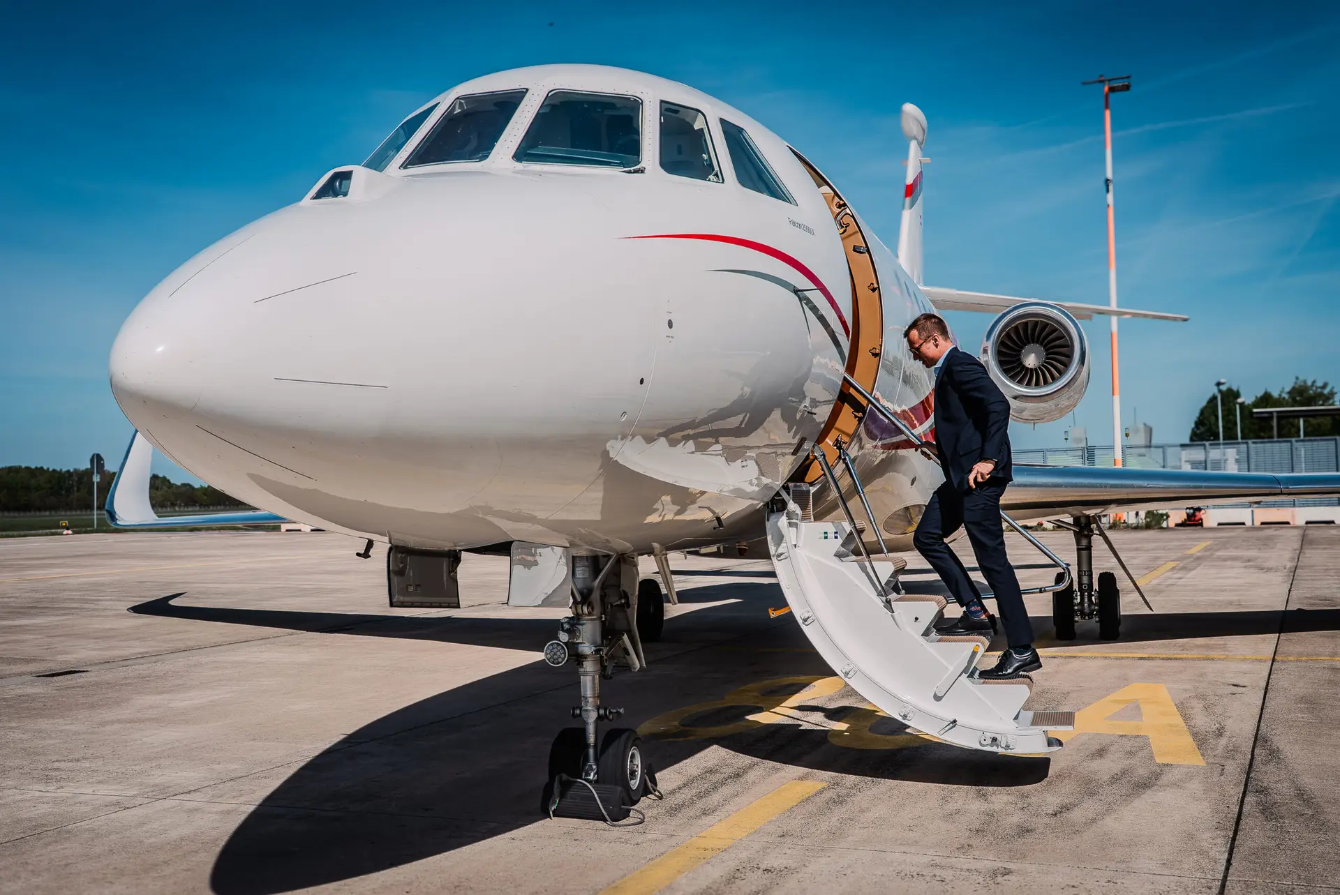 Swift wings CEO boarding a Falcon 2000LX private jet charter from Swift Wings